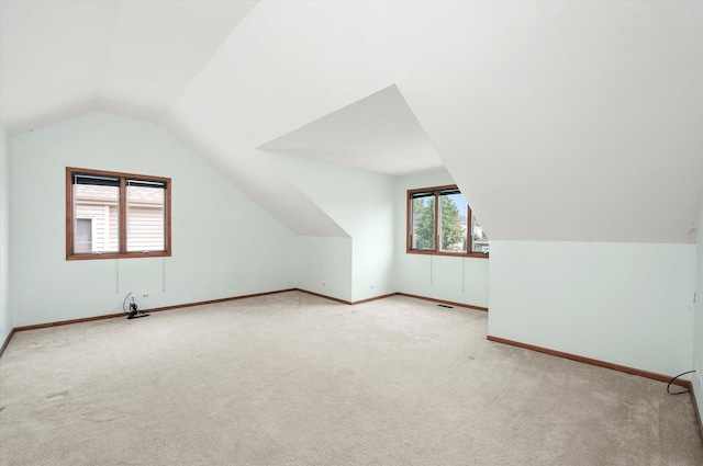 bonus room with carpet flooring and lofted ceiling