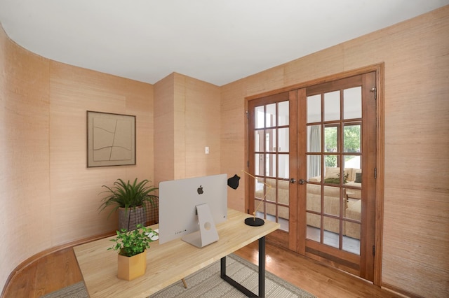 office with french doors and wood finished floors