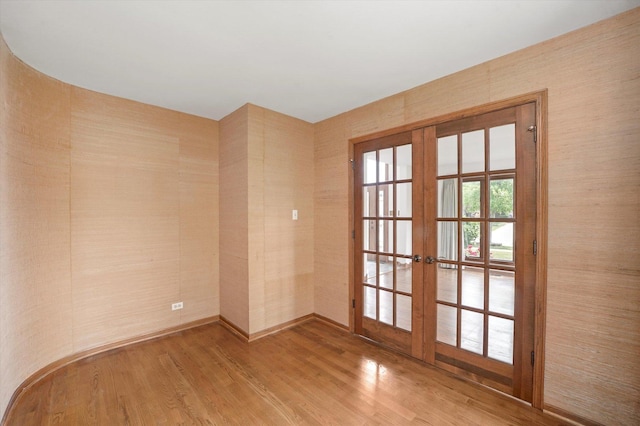 spare room featuring french doors and wood finished floors