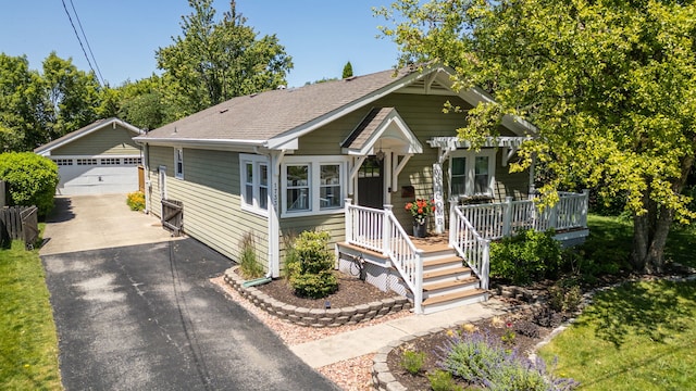 17336 65th Ave, Tinley Park, IL 60477 - bungalow featuring a garage, an outdoor structure, roof with shingles, and covered porch
