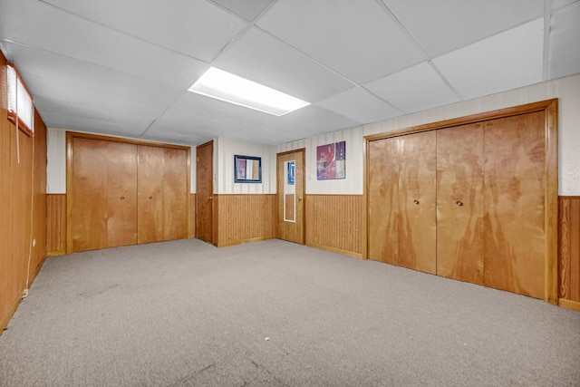 805 Highland Ave, Thornton, IL 60476 - unfurnished bedroom with wood walls, light carpet, a closet, and a paneled ceiling
