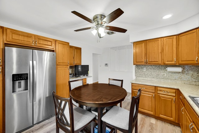 805 Highland Ave, Thornton, IL 60476 - kitchen featuring stainless steel refrigerator with ice dispenser, light wood-style flooring, decorative backsplash, and a ceiling fan