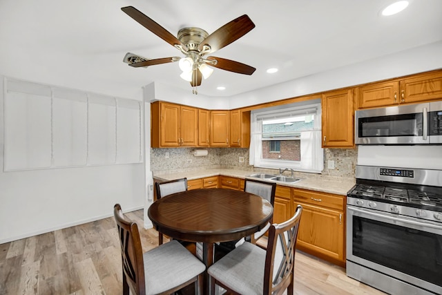 805 Highland Ave, Thornton, IL 60476 - kitchen featuring appliances with stainless steel finishes, a sink, light countertops, backsplash, and a ceiling fan