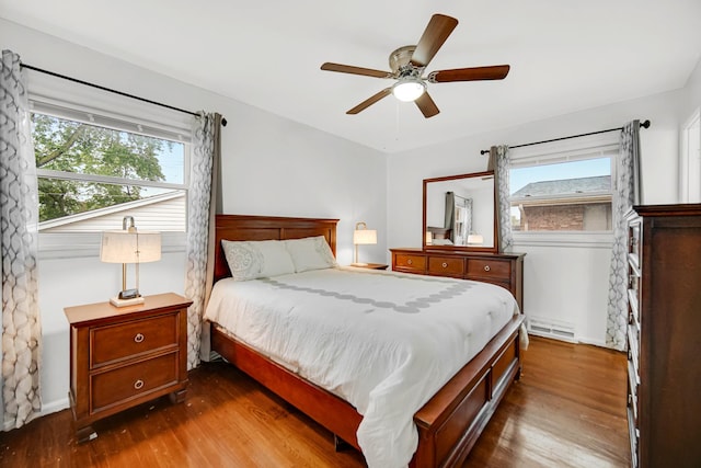 805 Highland Ave, Thornton, IL 60476 - bedroom featuring dark wood-style flooring, a baseboard heating unit, and multiple windows
