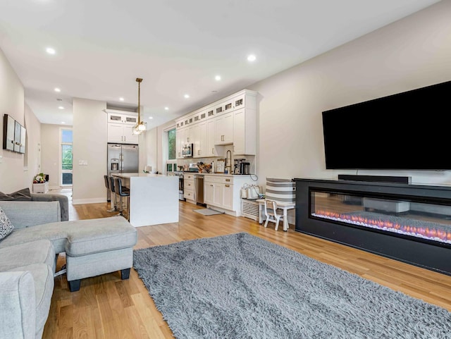 1707 S Jefferson St Unit 1, Chicago, IL 60616 - living room featuring light wood-style flooring, recessed lighting, and baseboards