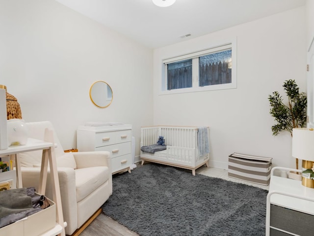 1707 S Jefferson St Unit 1, Chicago, IL 60616 - bedroom with a crib and baseboards