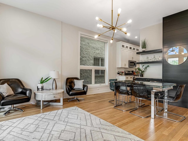 1707 S Jefferson St Unit 1, Chicago, IL 60616 - dining space featuring a chandelier and light wood-style flooring