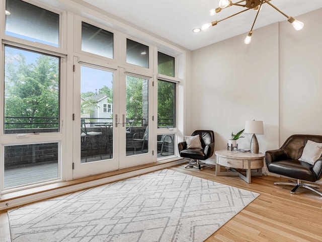 1707 S Jefferson St Unit 1, Chicago, IL 60616 - sitting room featuring healthy amount of natural light, wood finished floors, and a chandelier