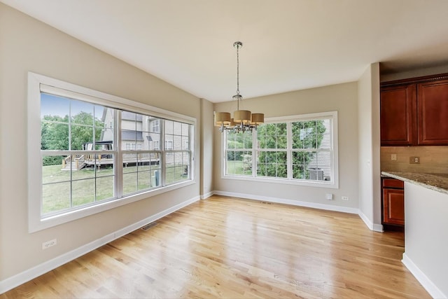 12354 S Blue Water Pkwy, Plainfield, IL 60585 - unfurnished dining area featuring a chandelier and light wood finished floors