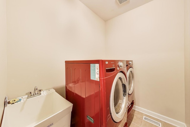 12354 S Blue Water Pkwy, Plainfield, IL 60585 - laundry area featuring washing machine and clothes dryer and light tile patterned flooring
