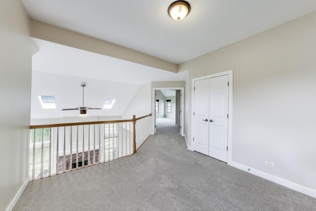 12354 S Blue Water Pkwy, Plainfield, IL 60585 - carpeted empty room featuring a skylight, ceiling fan, and vaulted ceiling
