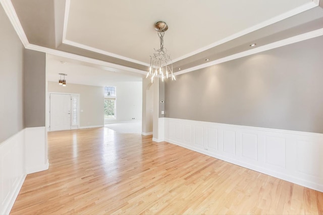 12354 S Blue Water Pkwy, Plainfield, IL 60585 - empty room featuring a raised ceiling, light wood-type flooring, crown molding, and a chandelier