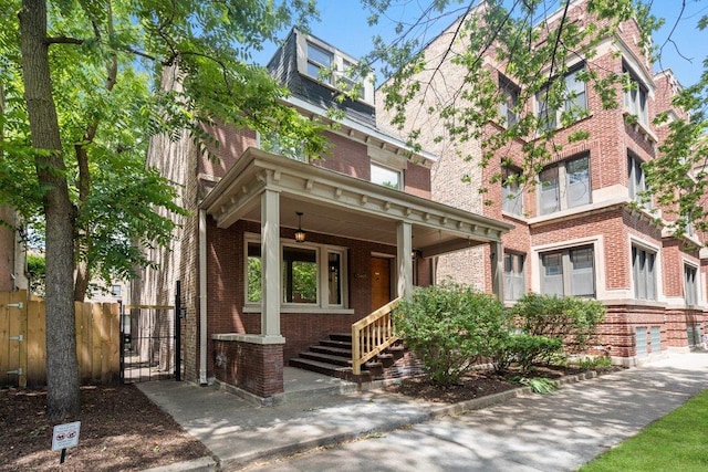 5468 S Ellis Ave, Chicago, IL 60615 - view of front of house featuring brick siding, a porch, and a gate