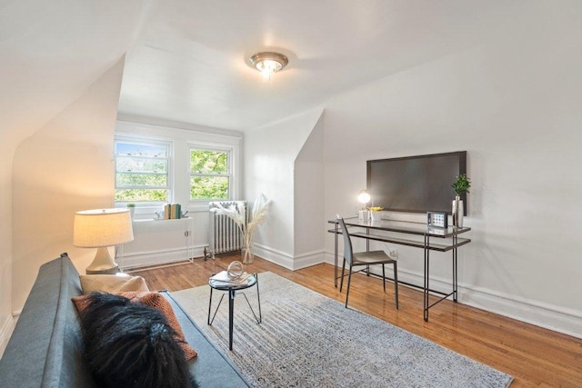 5468 S Ellis Ave, Chicago, IL 60615 - living area featuring radiator heating unit, wood finished floors, and baseboards