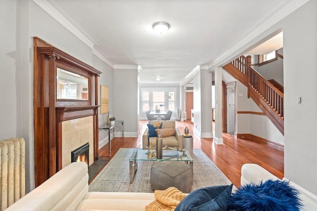 5468 S Ellis Ave, Chicago, IL 60615 - living area featuring radiator, a fireplace, ornamental molding, wood finished floors, and stairway