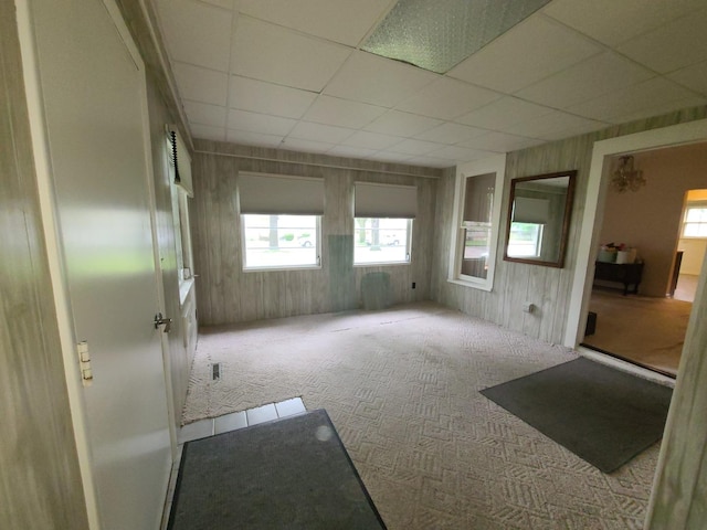 603 7th Ave, Sterling, IL 61081 - carpeted empty room featuring a paneled ceiling and wooden walls