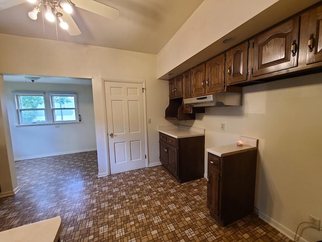 603 7th Ave, Sterling, IL 61081 - kitchen with under cabinet range hood, ceiling fan, dark brown cabinetry, light countertops, and baseboards