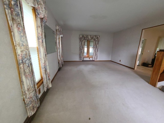 603 7th Ave, Sterling, IL 61081 - carpeted empty room with baseboards and french doors