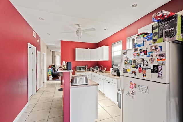 4512 S Fairfield Ave, Chicago, IL 60632 - kitchen featuring freestanding refrigerator, a sink, a ceiling fan, white cabinets, and light countertops