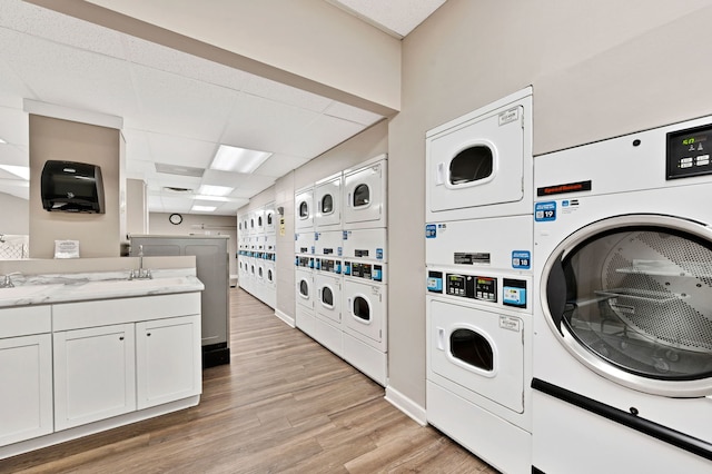 1636 N Wells St Unit 1503, Chicago, IL 60614 - communal laundry room with stacked washer / drying machine, washer and dryer, and light wood-type flooring
