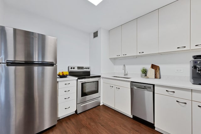 1636 N Wells St Unit 1503, Chicago, IL 60614 - kitchen featuring stainless steel appliances, a sink, light countertops, dark wood-style floors, and white cabinets