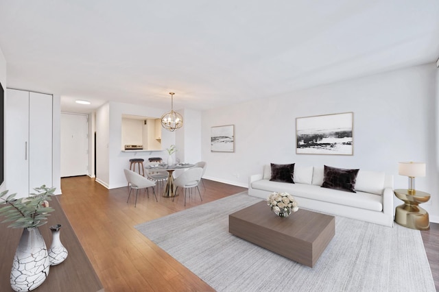 1636 N Wells St Unit 1503, Chicago, IL 60614 - living area with a chandelier, baseboards, and wood finished floors