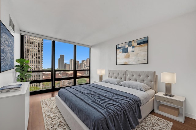 1636 N Wells St Unit 1503, Chicago, IL 60614 - bedroom featuring a skyline view, expansive windows, wood finished floors, and baseboards
