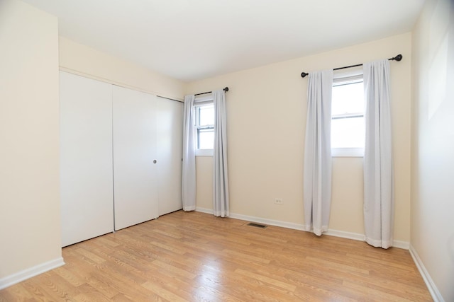 7930 164th Ct Unit 253, Tinley Park, IL 60477 - unfurnished bedroom with light wood-type flooring, baseboards, and a closet