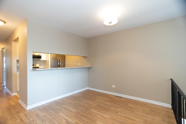 7930 164th Ct Unit 253, Tinley Park, IL 60477 - kitchen with stainless steel appliances, light wood-style flooring, and baseboards