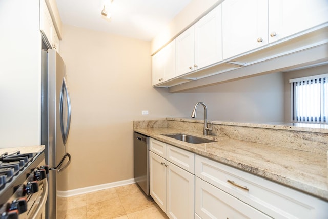 7930 164th Ct Unit 253, Tinley Park, IL 60477 - kitchen with stainless steel appliances, a sink, baseboards, white cabinets, and light stone countertops