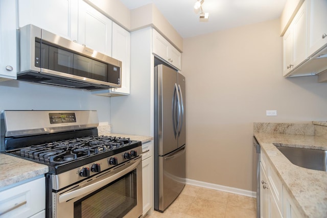 7930 164th Ct Unit 253, Tinley Park, IL 60477 - kitchen with appliances with stainless steel finishes, white cabinets, light stone countertops, baseboards, and light tile patterned floors