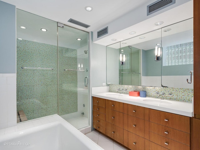1043 W Wolfram St Unit 1, Chicago, IL 60657 - bathroom featuring a stall shower, double vanity, a bath, recessed lighting, and tile patterned floors