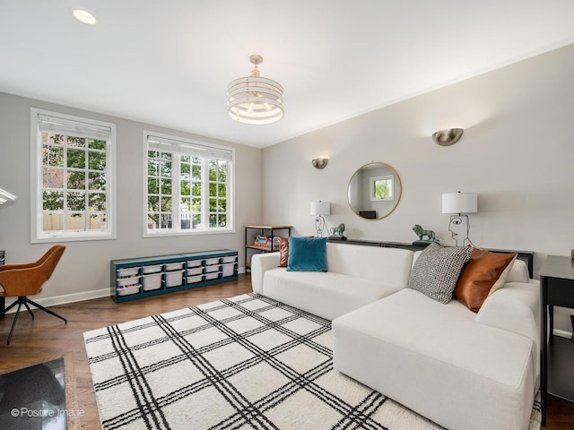 1043 W Wolfram St Unit 1, Chicago, IL 60657 - living room with wood finished floors, baseboards, and a chandelier