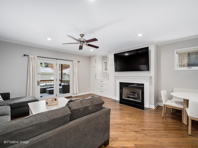 1043 W Wolfram St Unit 1, Chicago, IL 60657 - living room with ornamental molding, wood finished floors, ceiling fan, a fireplace with flush hearth, and recessed lighting
