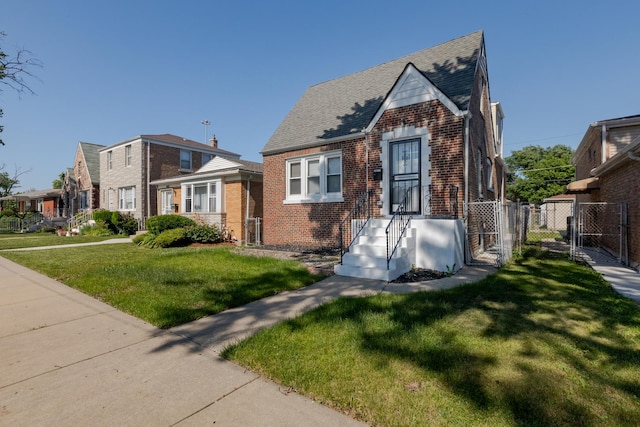 10017 S Indiana Ave, Chicago, IL 60628 - view of front facade featuring brick siding, a gate, and roof with shingles