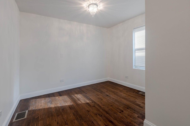 10017 S Indiana Ave, Chicago, IL 60628 - unfurnished room featuring dark wood-style flooring and a chandelier