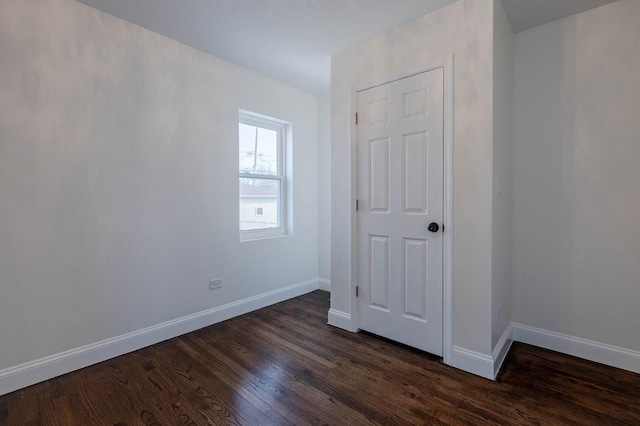 10017 S Indiana Ave, Chicago, IL 60628 - unfurnished bedroom featuring dark wood finished floors and baseboards
