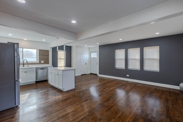 10017 S Indiana Ave, Chicago, IL 60628 - kitchen featuring stainless steel appliances, a kitchen island, open floor plan, light countertops, and dark wood-style flooring