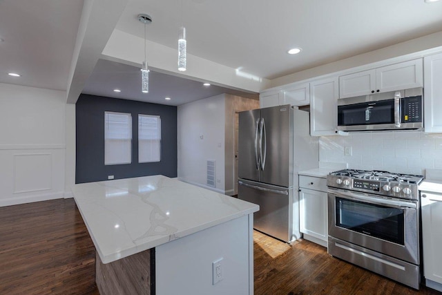 10017 S Indiana Ave, Chicago, IL 60628 - kitchen with stainless steel appliances, a center island, dark wood-type flooring, white cabinetry, and recessed lighting