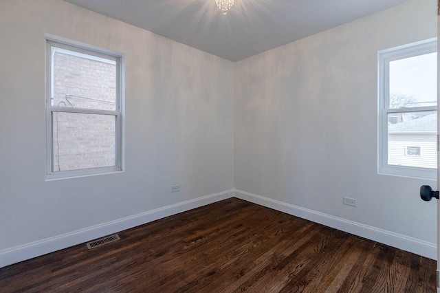 10017 S Indiana Ave, Chicago, IL 60628 - unfurnished room with dark wood-style flooring and healthy amount of natural light