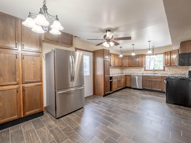 930 W Bryn Mawr Ave, Roselle, IL 60172 - kitchen with appliances with stainless steel finishes, ceiling fan, brown cabinets, and tasteful backsplash
