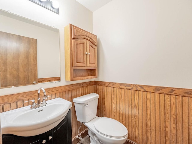 930 W Bryn Mawr Ave, Roselle, IL 60172 - bathroom with a wainscoted wall, vanity, toilet, and wood walls