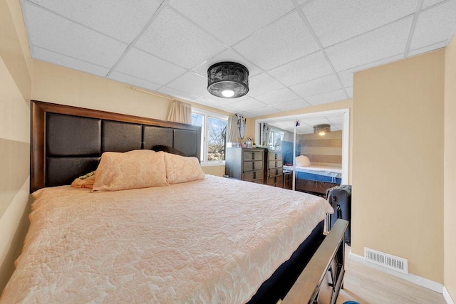18006 Oakwood Ave, Lansing, IL 60438 - bedroom with baseboards, a paneled ceiling, and wood finished floors