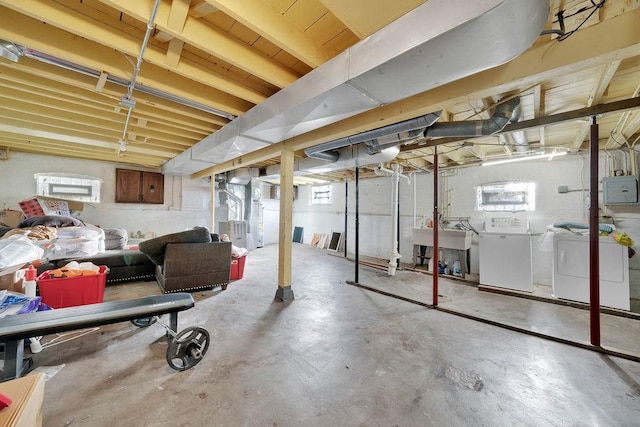 18006 Oakwood Ave, Lansing, IL 60438 - below grade area featuring washing machine and clothes dryer, electric panel, heating unit, and plenty of natural light