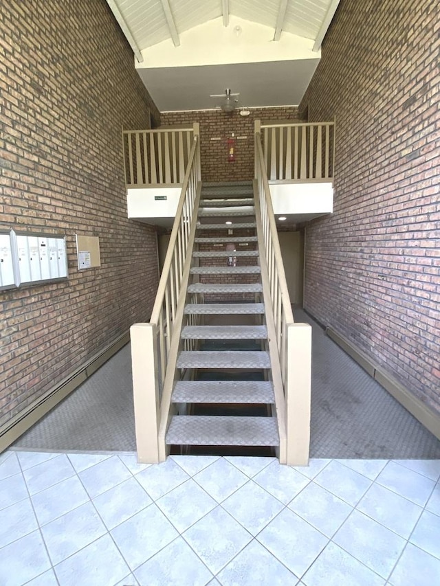 7413 Brookdale Dr Unit 103, Darien, IL 60561 - stairway with tile patterned floors, brick wall, high vaulted ceiling, and beam ceiling