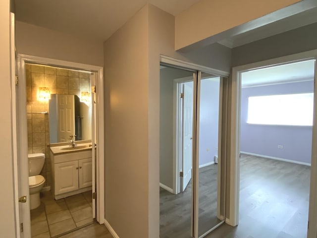 7413 Brookdale Dr Unit 103, Darien, IL 60561 - hallway featuring a sink and baseboards
