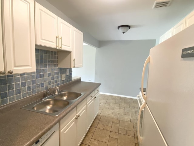7413 Brookdale Dr Unit 103, Darien, IL 60561 - kitchen with a sink, stone finish floors, decorative backsplash, and white cabinets