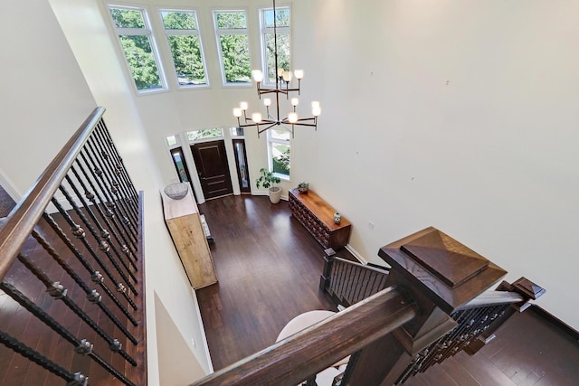 5843 N Oconto Ave, Chicago, IL 60631 - foyer with a chandelier, dark wood-style floors, a high ceiling, stairs, and baseboards