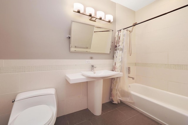 5843 N Oconto Ave, Chicago, IL 60631 - full bathroom with shower / bathtub combination with curtain, tile walls, toilet, tile patterned floors, and a wainscoted wall