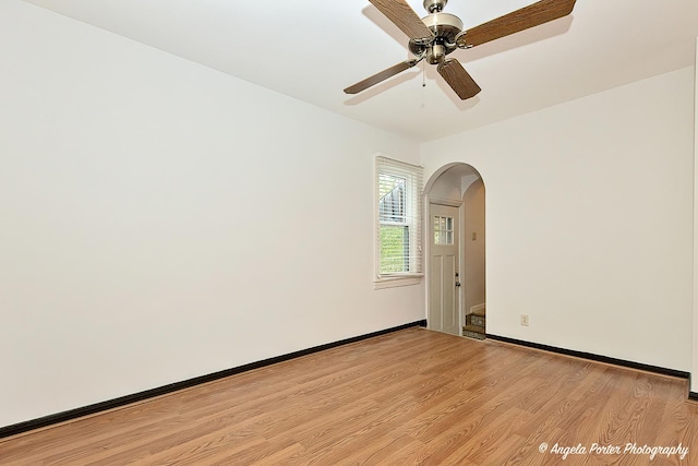 2618 Kashmiri Ave, Mchenry, IL 60050 - empty room featuring arched walkways, light wood-style flooring, a ceiling fan, and baseboards